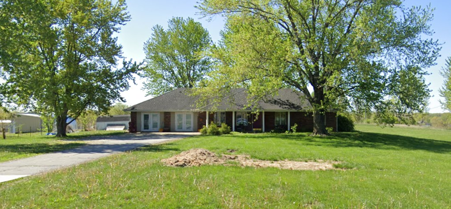 a house with a dirt mound in the front yard