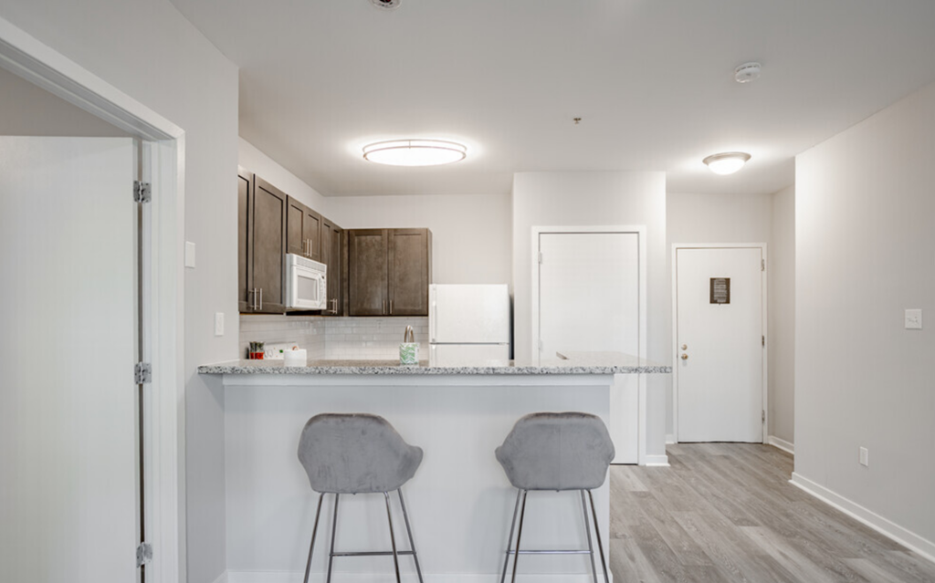 a kitchen with a counter top and two bar stools