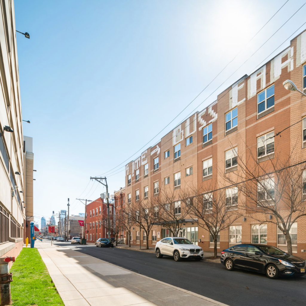 a large brick building on a city street with cars parked