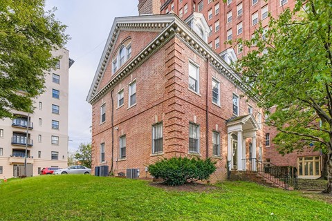 A red brick building with a white door and windows.