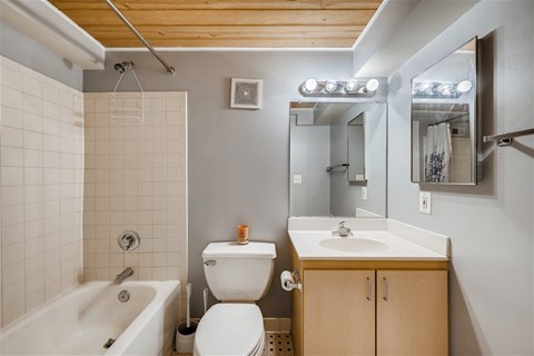 A white toilet sits next to a white sink in a small bathroom.