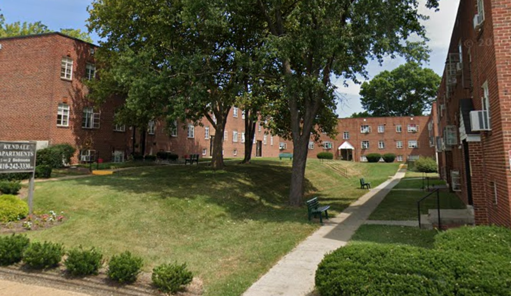 a park in front of a brick building
