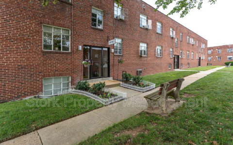a bench in front of a brick building