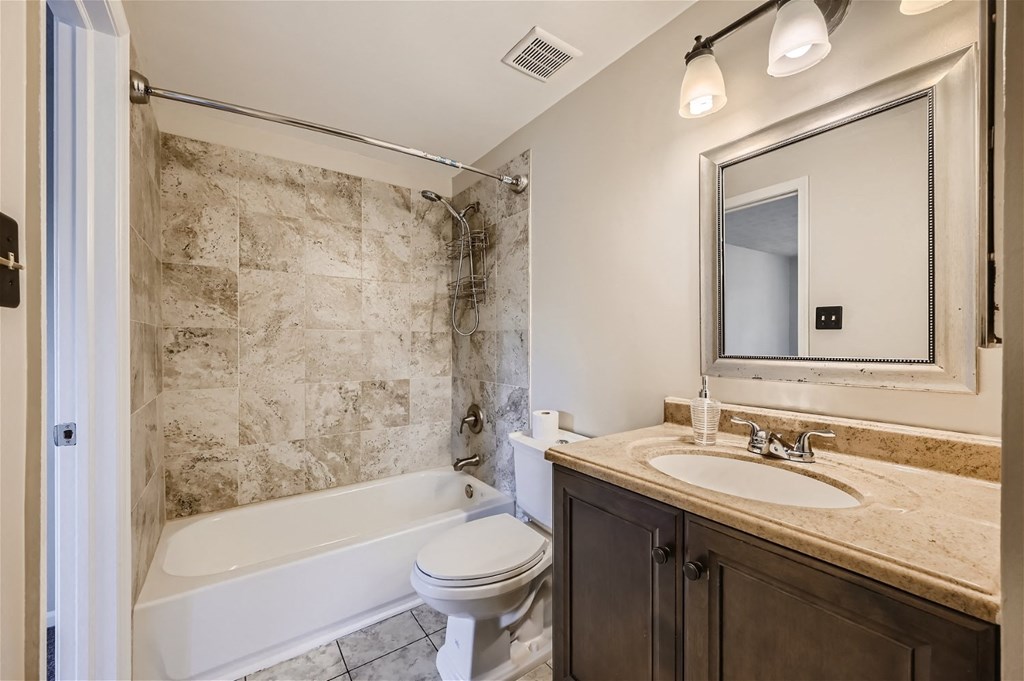 a bathroom with a sink toilet and a tub