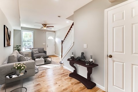 A living room with a grey couch and a wooden table.