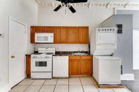 a kitchen with white appliances and wooden cabinets