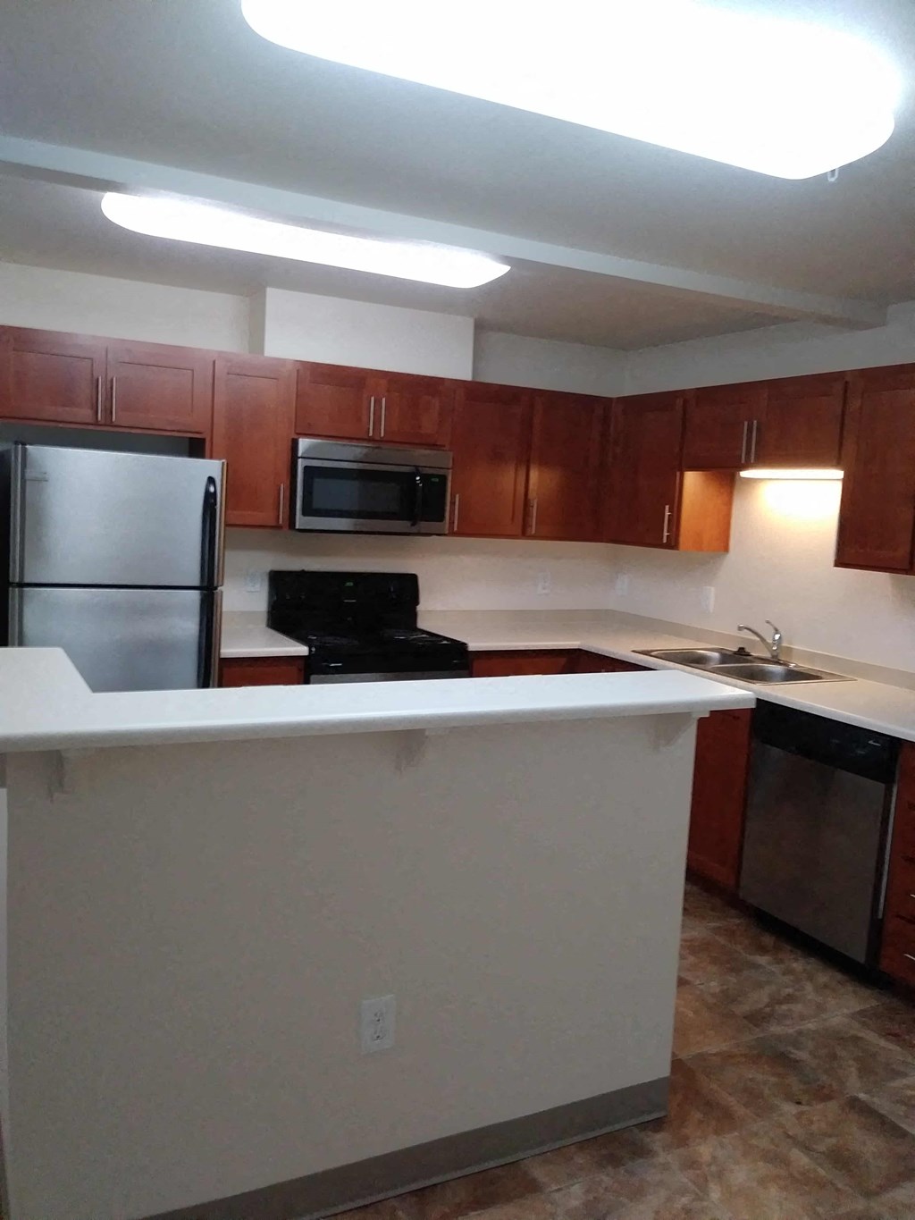 a kitchen with a counter top and a refrigerator