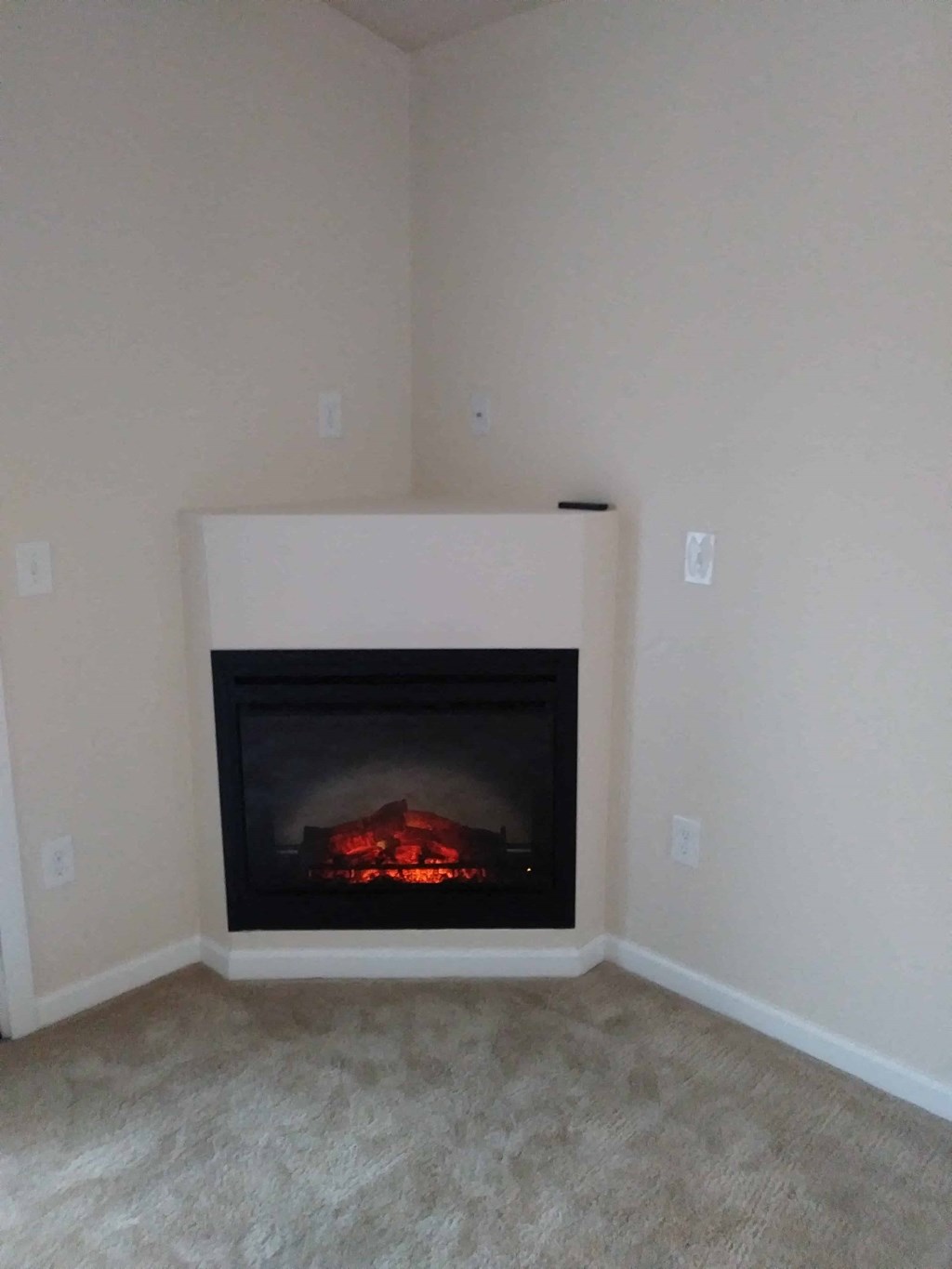 a fireplace in a living room with white walls