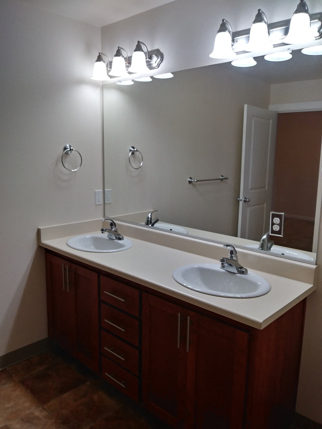 a bathroom with two sinks and a large mirror