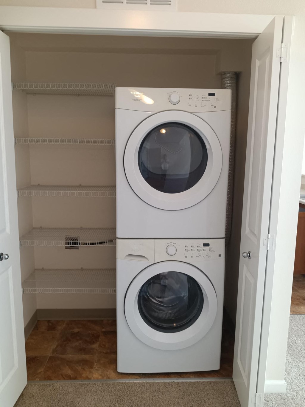 a front loading washer and dryer in a laundry room