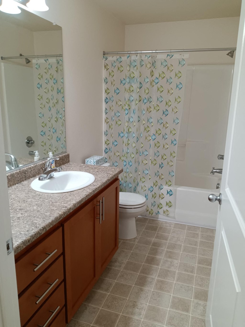 a bathroom with a sink and a toilet and a shower