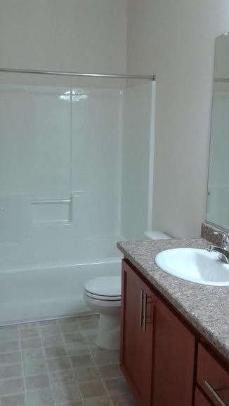 a bathroom with a sink and a toilet and a shower