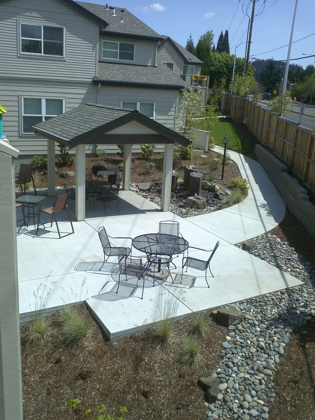 a patio with a table and chairs and a gazebo