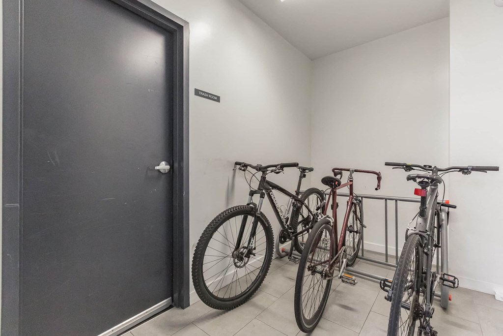 a group of bikes parked in a room next to a door