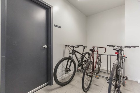 a group of bikes parked in a room next to a door