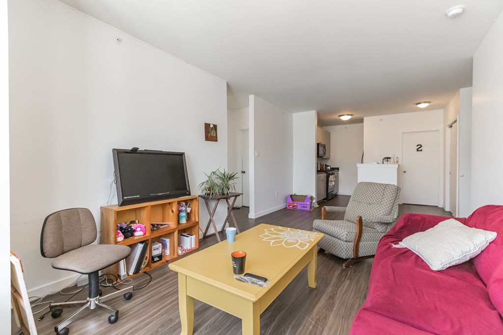 a living room with a red couch and a television