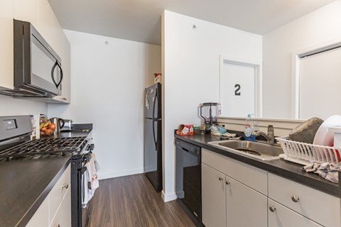 a kitchen with stainless steel appliances and a sink and refrigerator