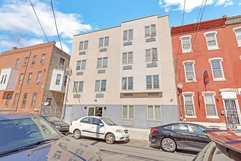 a white building with cars parked in front of it