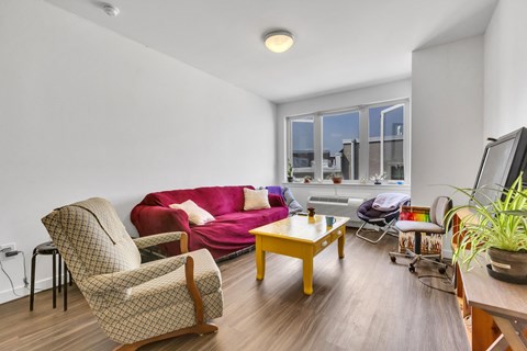a living room with a red couch and a tv