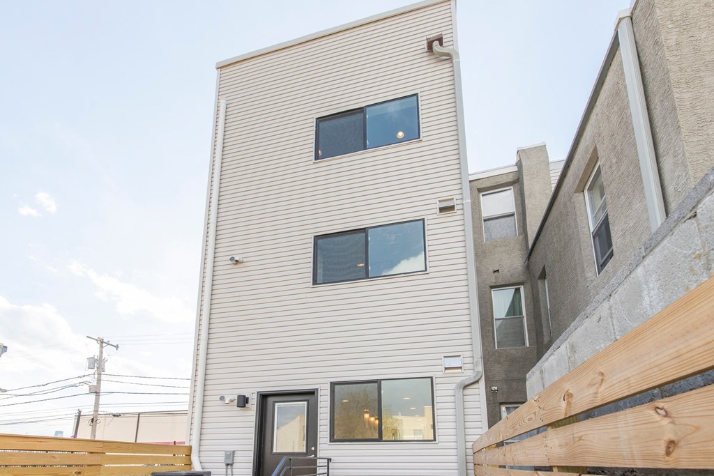 a white house with a wooden fence in front of it