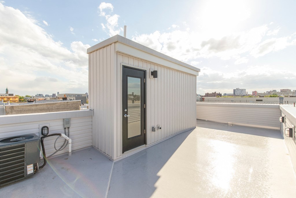 a small building on the roof of a building with a door