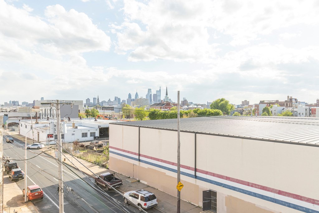 the side of a building with a city skyline in the background