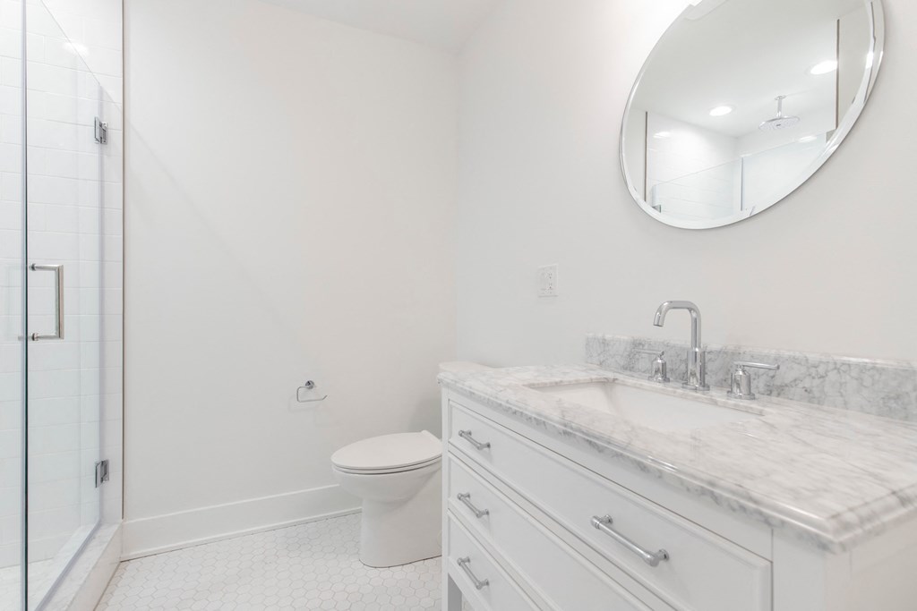 a bathroom with a sink and a toilet and a mirror