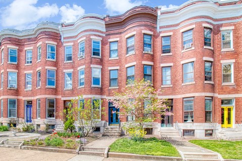 A red brick building with blue doors and windows.