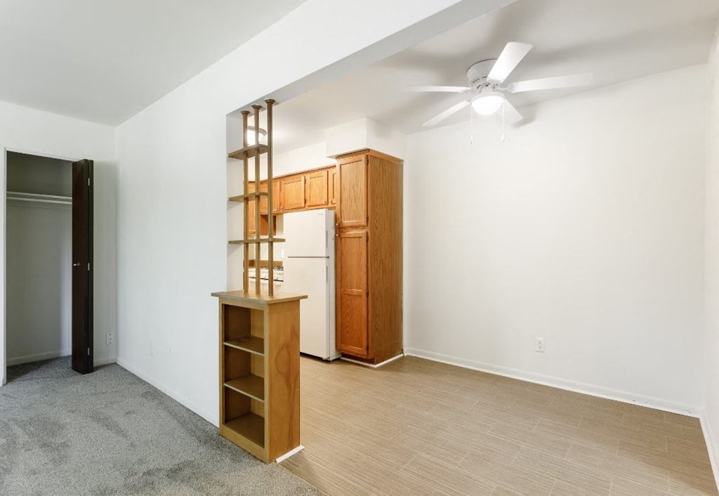 a living room with a wood floor and white walls