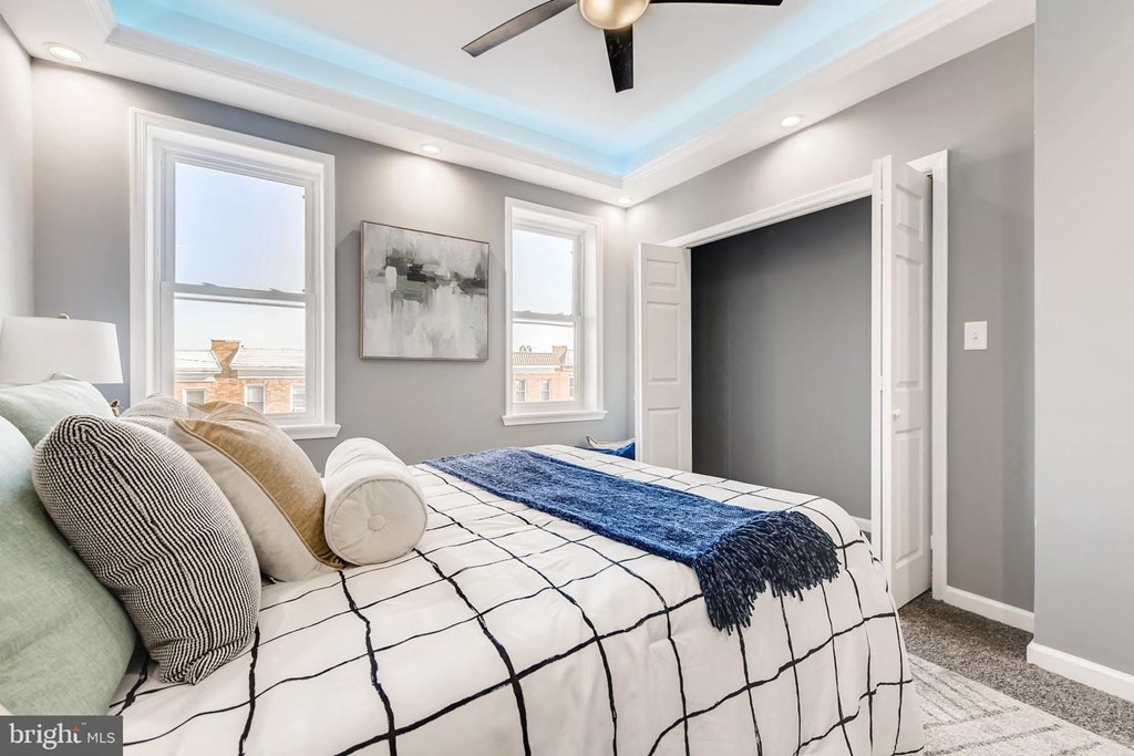 a bedroom with a bed and a ceiling fan