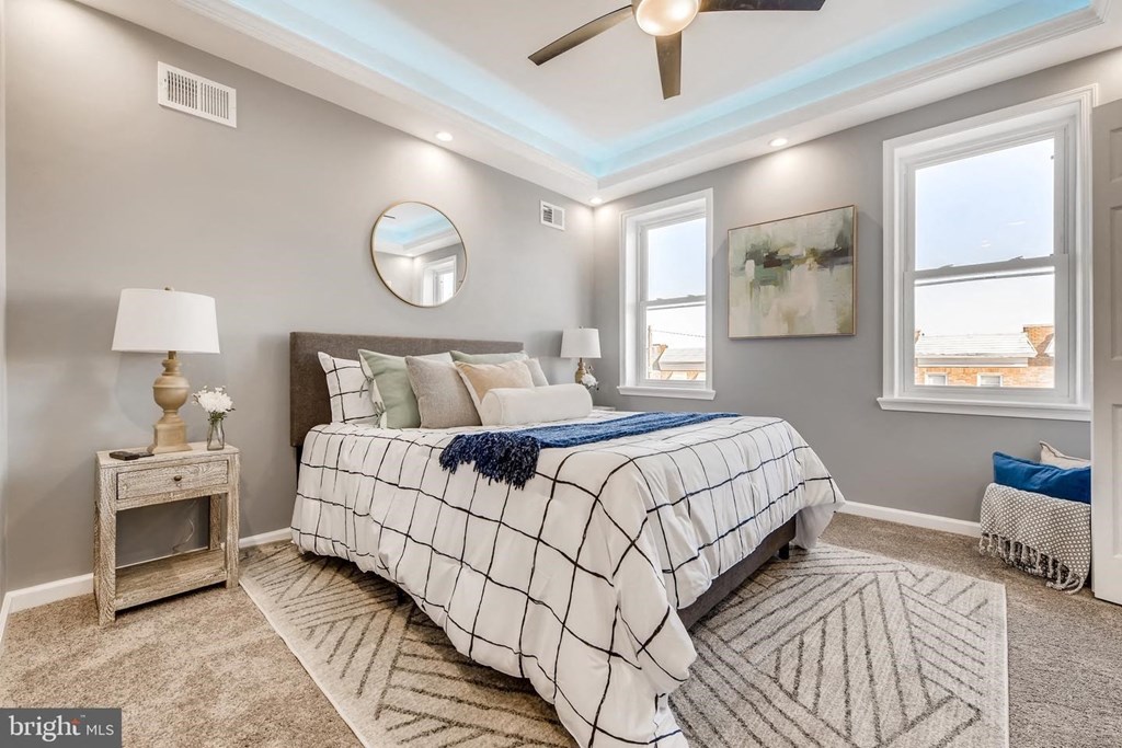 a bedroom with a bed and a ceiling fan
