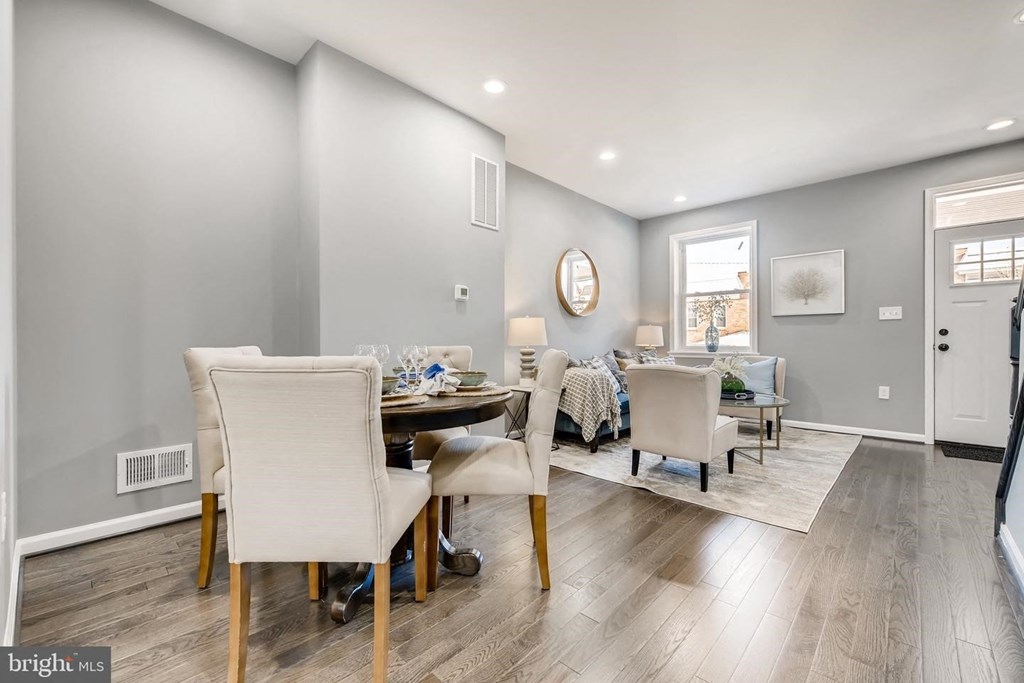 a dining room and living room with a table and chairs