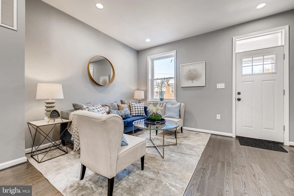 a living room with grey walls and a white door