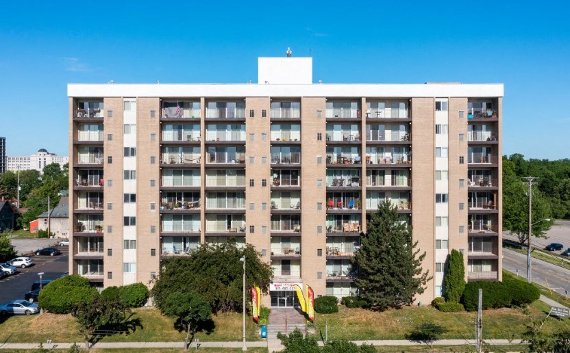 a large apartment building with a playground in front of it