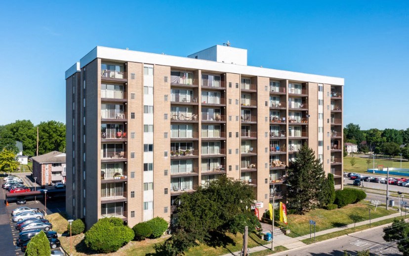 an aerial view of an apartment building in a parking lot