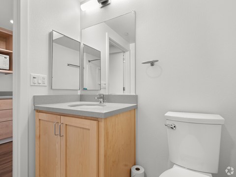 A white toilet sits next to a sink in a bathroom.