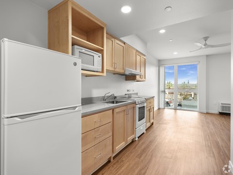A kitchen with wooden cabinets and a white refrigerator.