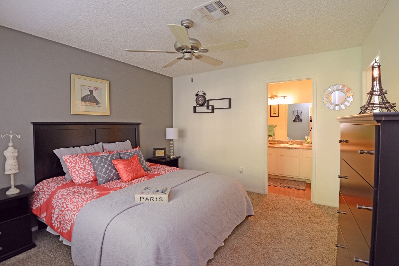 a bedroom with a bed and a ceiling fan