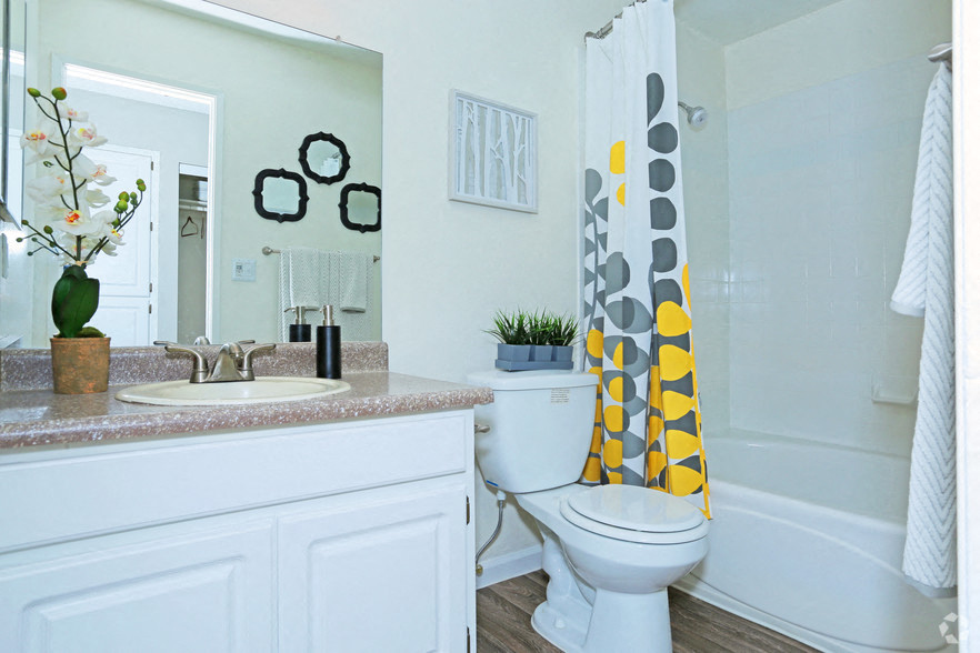 a bathroom with a sink and a toilet and a shower