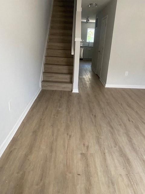 a living room with a staircase and a wooden floor
