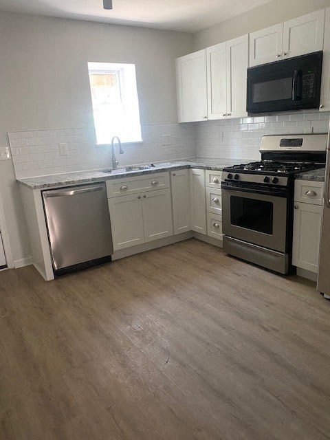 a kitchen with stainless steel appliances and white cabinets