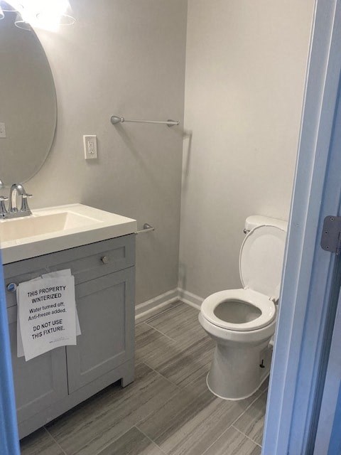 a bathroom with a toilet and a sink and a mirror