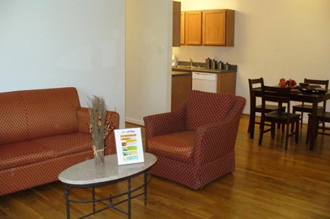a living room with a couch and chairs and a table