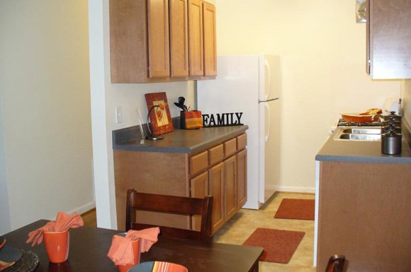 a kitchen with a table and a refrigerator