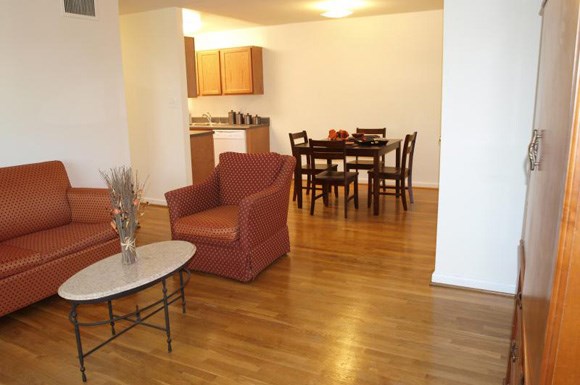 a living room and dining room with a table and chairs