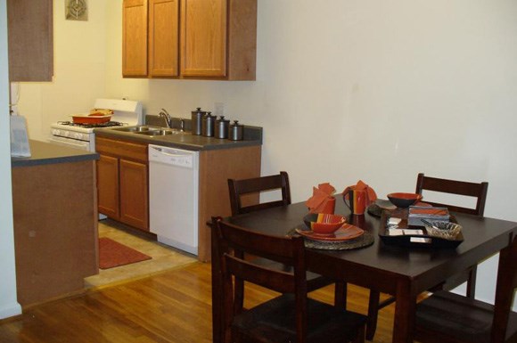 a kitchen and dining room with a table and chairs