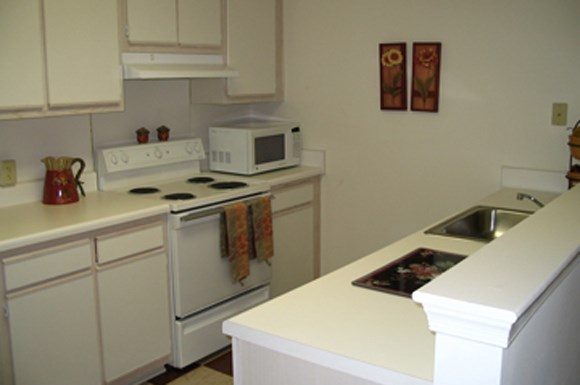 a kitchen with a stove microwave and sink