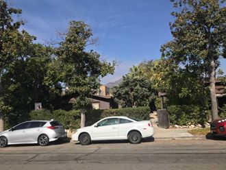 two white cars parked on the side of a street