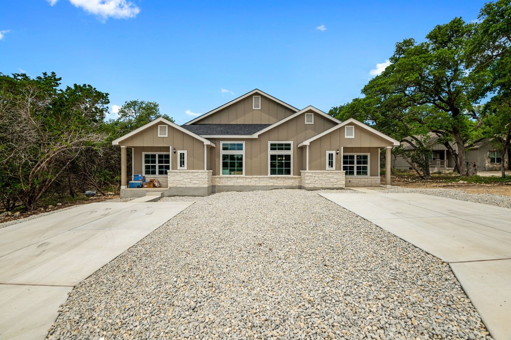 a house with a gravel driveway in front of it