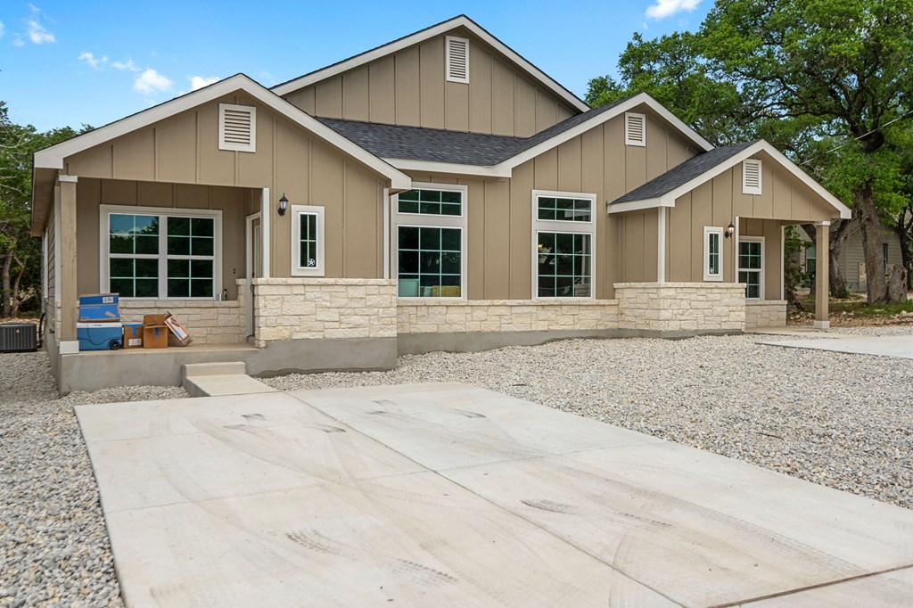 a new house with a concrete driveway and a patio